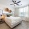 Cozy bedroom with ceiling fan and attached private bathroom at The Groves at Lake Juliana