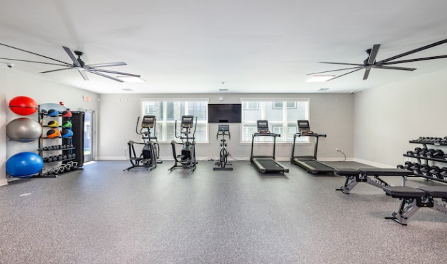 fitness center with pilates, cardio, and strength equipment fitness center with pilates, cardio, and strength equipment