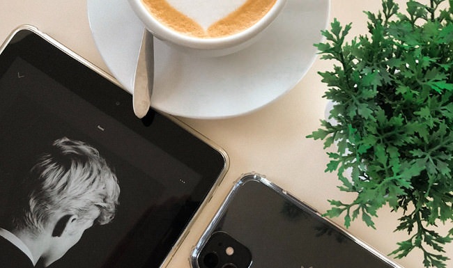 Stylish Interiors over head view of table top with a cup of coffee, ipad, iphone and potted plant